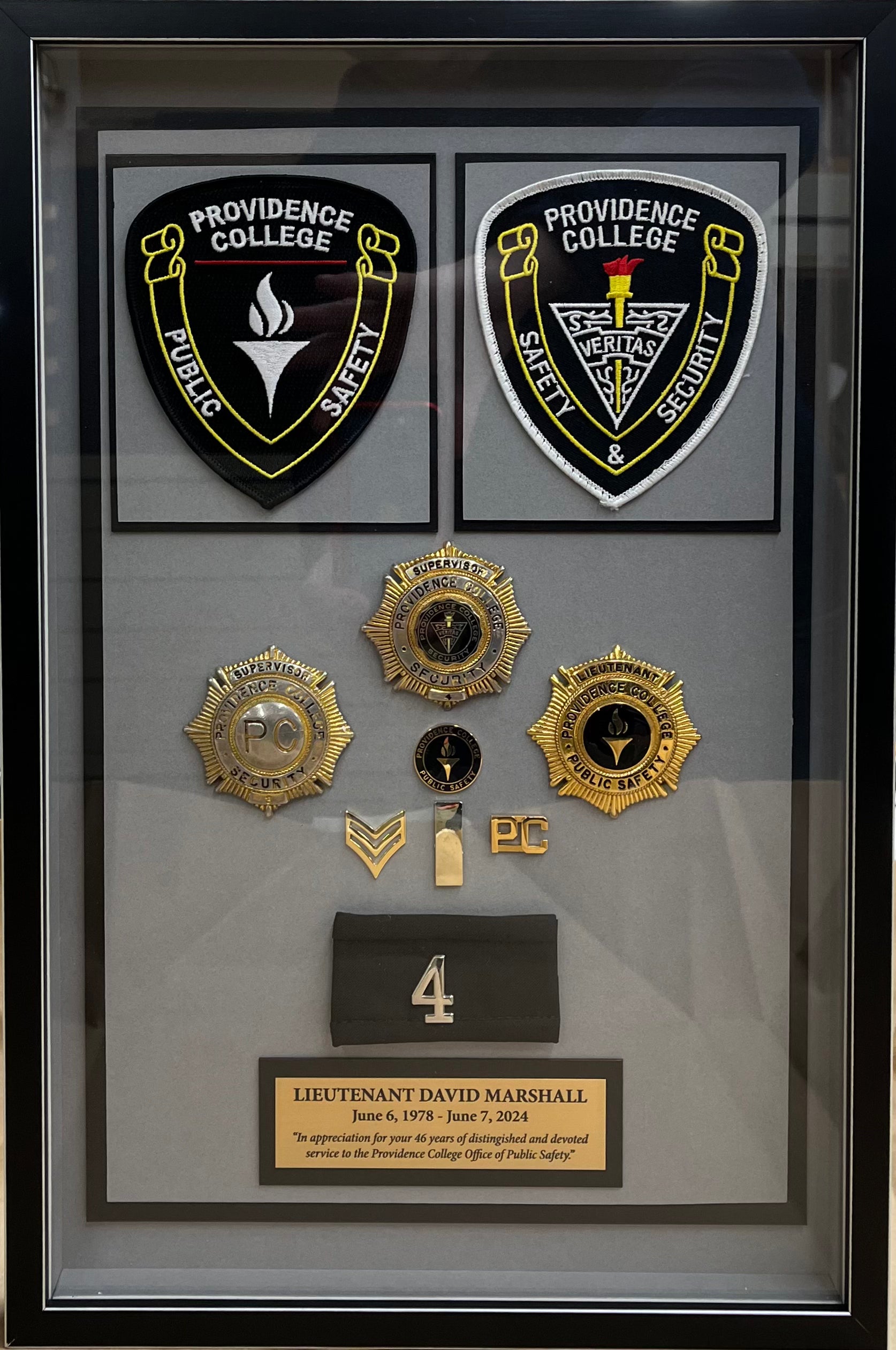 Custom framed shadow box with mounted Police badges and patches